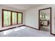 Bedroom with neutral carpet, large windows, and wood trim offering a bright and open space at 635 Kensington Dr, Chapel Hill, NC 27514