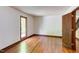 Bright bedroom featuring hardwood floors, natural light, and wooden trim at 635 Kensington Dr, Chapel Hill, NC 27514