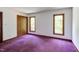 Bedroom featuring a carpeted floor, closet space, and natural light from two windows at 635 Kensington Dr, Chapel Hill, NC 27514