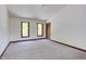 Spacious bedroom featuring neutral carpeting, large windows, and a closet for ample storage at 635 Kensington Dr, Chapel Hill, NC 27514