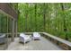 Relaxing deck featuring modern chairs and bench surrounded by lush greenery, perfect for outdoor enjoyment at 635 Kensington Dr, Chapel Hill, NC 27514