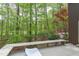 View of deck overlooking lush backyard with built in bench at 635 Kensington Dr, Chapel Hill, NC 27514