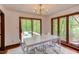 Bright dining area with modern chandelier, table, and seating overlooking a deck with natural views at 635 Kensington Dr, Chapel Hill, NC 27514