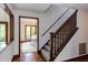 Inviting entryway featuring hardwood floors, a staircase, and an open view to the dining room at 635 Kensington Dr, Chapel Hill, NC 27514