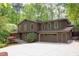 Two-story home featuring neutral brown siding, a spacious driveway, and lush trees at 635 Kensington Dr, Chapel Hill, NC 27514
