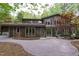 Stunning home featuring a brick patio and mature trees, offering a private outdoor space at 635 Kensington Dr, Chapel Hill, NC 27514