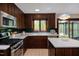 The well-equipped kitchen has dark cabinets, white countertops, and stainless steel appliances at 635 Kensington Dr, Chapel Hill, NC 27514