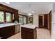 Rustic kitchen featuring warm wood cabinetry, stainless steel appliances, and an island at 635 Kensington Dr, Chapel Hill, NC 27514