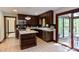 A charming kitchen with dark cabinetry, an island, and stainless steel appliances next to a sliding glass door at 635 Kensington Dr, Chapel Hill, NC 27514
