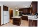 Well-lit kitchen with wooden cabinets, island, and appliances, providing ample space and functionality at 635 Kensington Dr, Chapel Hill, NC 27514