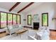 Cozy living room with vaulted ceiling, fireplace, comfortable seating, and expansive windows at 635 Kensington Dr, Chapel Hill, NC 27514