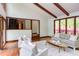 Open living room with seamless access to the staircase and an abundance of natural light from large windows at 635 Kensington Dr, Chapel Hill, NC 27514