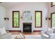 Living room showcasing a fireplace and large windows offering natural light and scenic views at 635 Kensington Dr, Chapel Hill, NC 27514