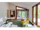 Bright living room featuring a sunroom, modern furnishings, and a view to the kitchen at 635 Kensington Dr, Chapel Hill, NC 27514