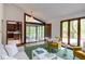 Bright living room featuring a sunroom, modern furnishings, and a view to the kitchen at 635 Kensington Dr, Chapel Hill, NC 27514