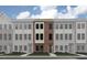 Modern townhouse exterior features a brick facade, symmetrically placed windows, and a well-manicured lawn at 668 Bandon Aly, Cary, NC 27513