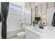 Cozy bathroom featuring white tiling, a new vanity, and natural light from the bright window at 668 Bandon Aly, Cary, NC 27513