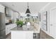 Well-lit open kitchen with large island, pendant lights, and barstool seating at 668 Bandon Aly, Cary, NC 27513