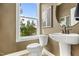Stylish powder room with pedestal sink, modern fixtures, and natural light from the window at 668 Bandon Aly, Cary, NC 27513