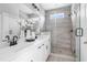 Modern bathroom with double sinks, tile floors, a glass shower, and sleek fixtures, blending style and functionality at 670 Bandon Aly, Cary, NC 27513