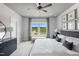 Serene bedroom with a ceiling fan, natural light, and neutral decor, providing a peaceful retreat for rest and relaxation at 670 Bandon Aly, Cary, NC 27513