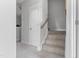Hallway staircase with a light neutral carpet and white painted trims at 670 Bandon Aly, Cary, NC 27513