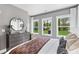 Bedroom featuring carpet, queen bed, 3 windows with a view of the outdoors, and dark wood floors at 679 Bandon Aly, Cary, NC 27513