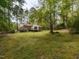 Expansive backyard surrounded by lush greenery and mature trees at 6813 W Lake Anne Dr, Raleigh, NC 27612