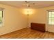 Cozy bedroom with wood-look floors, neutral walls, ceiling fan, and dresser at 6813 W Lake Anne Dr, Raleigh, NC 27612