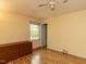 Bedroom features laminate floors, a ceiling fan, a large dresser, and natural light at 6813 W Lake Anne Dr, Raleigh, NC 27612