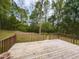 Spacious wooden deck overlooking a private backyard with mature trees at 6813 W Lake Anne Dr, Raleigh, NC 27612