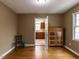 Spacious dining room with hardwood floors and natural light, with a view into the kitchen at 6813 W Lake Anne Dr, Raleigh, NC 27612