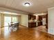 Open kitchen and dining area with wood cabinets, tile flooring, and access to the backyard at 6813 W Lake Anne Dr, Raleigh, NC 27612