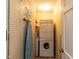Small laundry room area with stacked washer and dryer hookups and a peg board wall at 6813 W Lake Anne Dr, Raleigh, NC 27612
