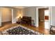 Open floor plan with hardwood floors, a piano, and views into other rooms of the home at 6813 W Lake Anne Dr, Raleigh, NC 27612
