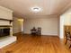 Spacious living room with hardwood floors and a brick fireplace with mantle at 6813 W Lake Anne Dr, Raleigh, NC 27612