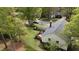 Aerial view of a backyard with wood deck, greenery, and privacy fence at 700 Sawmill Rd, Raleigh, NC 27615