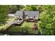 Aerial view of a home with fenced-in backyard, wood deck, and green grass at 700 Sawmill Rd, Raleigh, NC 27615