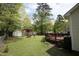 Beautiful backyard with a deck, a shed, and mature trees at 700 Sawmill Rd, Raleigh, NC 27615