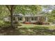 Charming single-story home featuring a manicured lawn, mature trees, and a welcoming front entrance at 700 Sawmill Rd, Raleigh, NC 27615