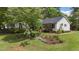 Charming one-story home with a beautiful landscaped front yard and flowering trees at 700 Sawmill Rd, Raleigh, NC 27615