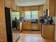 Galley kitchen featuring stainless appliances, light wood cabinets and a window over the sink at 700 Sawmill Rd, Raleigh, NC 27615