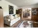 Inviting living room featuring a comfortable sofa, stylish decor, and an open layout to the dining area at 700 Sawmill Rd, Raleigh, NC 27615
