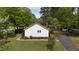 The rear of the home shows the side yard, driveway, and greenery at 700 Sawmill Rd, Raleigh, NC 27615