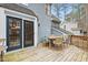 Home's wooden deck is set for outdoor entertaining, and has sliding glass door access to inside at 7112 Benhart Dr, Raleigh, NC 27613