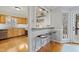 Breakfast bar featuring hardwood floors with a view into the kitchen area at 7112 Benhart Dr, Raleigh, NC 27613