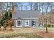 Charming single-story home featuring a bay window, brick chimney, and a well-manicured front yard at 7112 Benhart Dr, Raleigh, NC 27613