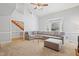 Bright living room featuring vaulted ceiling, comfortable sectional sofa, and a large bay window at 7112 Benhart Dr, Raleigh, NC 27613
