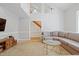 Comfortable living room with high ceilings, large sectional sofa, and view to the staircase at 7112 Benhart Dr, Raleigh, NC 27613