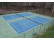 Aerial view of a well-maintained tennis court shows a great amenity at 7112 Benhart Dr, Raleigh, NC 27613